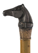 HORSE RACING IN TASMANIA: A RIDING CROP, topped with horse's head, engraved "Tasmanian Turf Club 1879", and with a 9ct gold collar engraved "Ladies Cup, Won By Swiveller, Wm Martin, 13st 12lbs".Swiveller had also won the Hobart Cup in 1878 and the Launces - 2