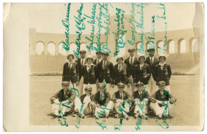 The Australian Team in Los Angeles 1932: A photographic postcard of the whole team in their Olympic Uniforms in front of the Olympic Stadium. The postcard has been signed by all 13 athletes and 3 officials, including Clare Dennis, Bobby Pearce and Duncan Gray, the three Gold Medallists. Andrew "Boy" Charlton was the flag bearer of the contingent, smaller than planned because of financial constraints resulting from the Great Depression. The card is endorsed to the recipient by Billy Barwick, als