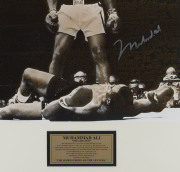 MUHAMMAD ALI "The Greatest" signed photograph, showing Ali standing over Sonny Liston in their 1965 fight; framed and glazed; overall 82 x 81cm. With Superstars & Legends CofA. - 2