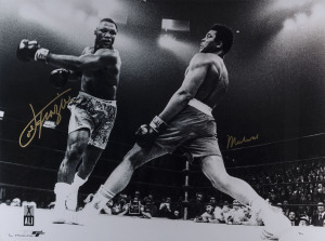 MUHAMMAD ALI & JOE FRAZIER original signatures on a large black & white action photograph from the bout at Madison Square Garden on March 8, 1971. Framed and glazed; overall 110 x 135cm. Accompanied by original Certificate of Authenticity, valuation and b