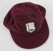CURTLY AMBROSE'S WEST INDIES TEST TEAM CAP, maroon wool with the West Indies logo embroidered to front. Cap by Bill Edwards of Swansea with Ambrose's name in pen on the label (partly overwritten). Attractively framed. [Ambrose played in 98 Tests for the W - 3