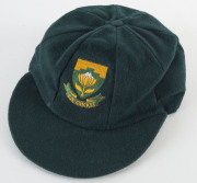 PAT SYMCOX'S SOUTH AFRICA "BAGGY GREEN" TEST CAP, green wool, embroidered Protea & "S.A.CRICKET" on front, Albion label inside endorsed "PS". [Symcox, a tall off-spinner, played 20 Tests 1993-99]. Ex South African cricket writer Brian Bassano, with letter - 3