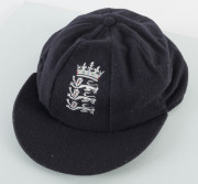 DEVON MALCOLM'S ENGLAND HOME TEST TEAM CAP, navy blue wool with embroidered Crown over three lions on front, with "D.M." to inside label. Very fine condition. Attractively framed. - 3