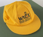 JO ANGEL'S WESTERN AUSTRALIA CAP, yellow wool with the WACA logo embroidered to front and signed beneath the peak by Jo Angel. Attractively framed.A giant fast bowler standing 6 feet 6 inches (198 cm) tall, Angel took 485 first-class wickets, including 44 - 3