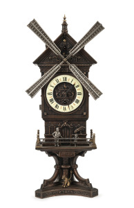 French "Windmill" automaton clock, bronze finished metal case with enamel dial, circa 1890, This clock has two separate wind movements, one for the hands, the other to strike the bell and move the mill, placard below the doors read "MOULIN JOLY", 42cm hig