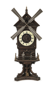 French "Windmill" automaton clock, bronze finished metal case with enamel dial, circa 1890, This clock has two separate wind movements, one for the hands, the other to strike the bell and move the mill, placard below the doors read "MOULIN JOLY", 42cm high