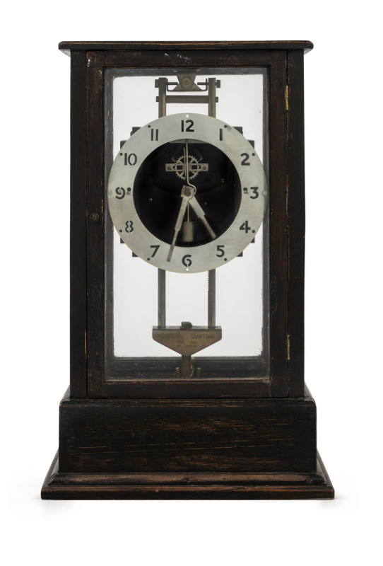 GRAVITY Clock in oak case, England, circa 1900, when the movement is elevated a tooth rack on one of the columns is engaged and the movements own weight will drive the clock for 24 hours, ​35cm high