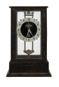 GRAVITY Clock in oak case, England, circa 1900, when the movement is elevated a tooth rack on one of the columns is engaged and the movements own weight will drive the clock for 24 hours, ​35cm high