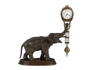 ELEPHANT Mystery clock by Junghans, German, late 19th early 20th century, 8 day movement supported on bronze finished elephant statue sitting on wooden base, 28cm