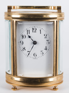 A French oval brass and glass cased carriage clock with Arabic numerals, 19th century, 15cm high