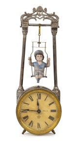 ANSONIA SWINGING Doll clock, gilt and silvered metal case, circa 1889, dial marked with Ansonia monogram "Patented April 2nd, 1889", 30cm high