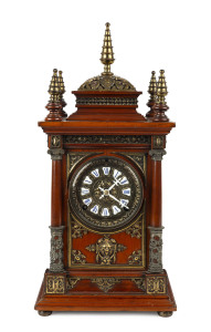 ANSONIA "Antique" mantel clock with enamel cartouche numerals, rosewood case with ornate gilt metal decoration and turned finials, circa 1894, ​46cm high