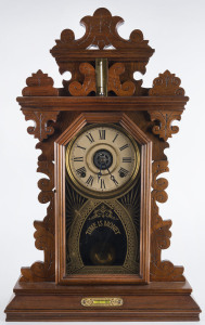 E. INGRAHAM CLOCK Co. "Pansy" 8 day time and strike alarm shelf clock with additional thermometer and spirit level, walnut case, original glass with inscription "Time Is Money", circa 1890, 61.5cm high