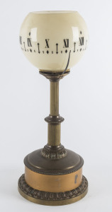 A French night light clock, gilt metal case with original rotating opaque cream glass shade, 19th century, 34cm high