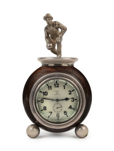 Early Swiss automobile clock mounted as a bowling trophy, 8 day Brevete movement housed in a lignum vitae bowl adorned with silver plated bowling figure, circa 1920. Bezel wind and time setting done by applying pressure to the glass. 20cm high