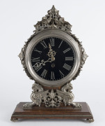 A Continental mantel clock, nickel plate on oak platform base with black glass Roman numeral dial, 19th century ​40cm high