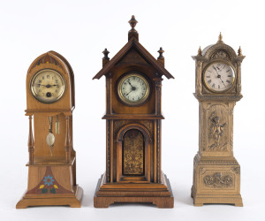 Three miniature grandfather clocks, timber and cast iron cases, 20th century, the tallest 32cm high