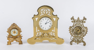 Three ornate brass cased clocks comprising Ansonia bedside clock, British United Clock Co. Birmingham lyre shaped clock, and French mantel clock, 19th century, the tallest 28cm high