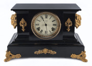 ANSONIA "Brandon", 8 day hour and half hour time and strike shelf clock with black metal case adorned with gilt metal bison heads, scarce model, circa 1904, 27cm high