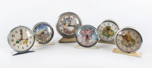 Six novelty alarm clocks in cream enamel cases, 20th century, tallest 16cm high