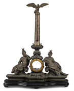 An American pocket watch stand, ornately cast and figured spelter with silvered column and thermometer on ebonized timber base, 19th century, 41cm high