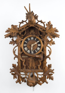 Black Forest cuckoo 2 horn Trumpeter, cuckoos at the quarter hour and the hour is followed by a horn announcement, pine case with spring driven movement, circa 1870s, with Swiss retailers plaque on the front. 84cm high