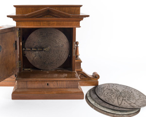 POLYPHON Musical clock in architectural timber case, with 6 discs, circa 1900, ​Junghans movement with Regina player. 56cm high