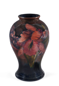 A MOORCROFT iris pattern flambe pottery vase, circa 1930s, impressed signature and stamp with original paper label "By appointment to her Majesty the Queen". 16cm high