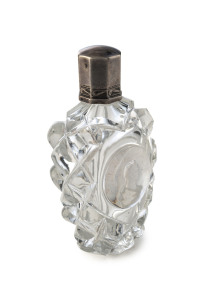 A French Baccarat sulphide scent bottle. Facet cut with cameo portrait of Napoleon. Original glass stopper and silver lid, circa 1850, 7.5cm high