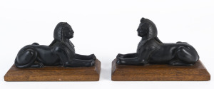 A pair of spelter sphinx bookends on wooden bases, early 20th century, 11cm high, 19cm long