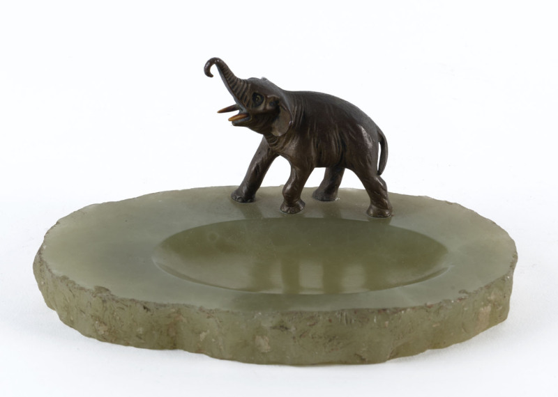 An Austrian cold painted bronze elephant mounted on a green stone dish, circa 1900, 8cm high, 17cm across