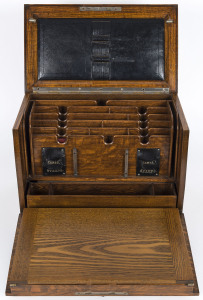 An English oak compendium with fold out writing slope, late 19th century, 28cm high, 38cm wide, 22cm deep