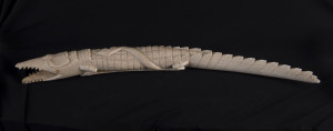 A carved African ivory figure of a crocodile and snake, circa 1930s, 52cm long
