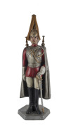 A fireside companion set in the form of a guardsman, painted metal, mid 20th century, 66cm high