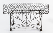 A Victorian wirework plant stand, 19th century, 43cm high, 76cm wide, 27cm deep