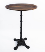 A cafe or hotel table, cast iron base with woodgrain finished top, late 20th century, 110cm high, 70cm diameter