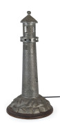 A lighthouse table lamp, cast metal on timber base, circa 1930, 45cm high