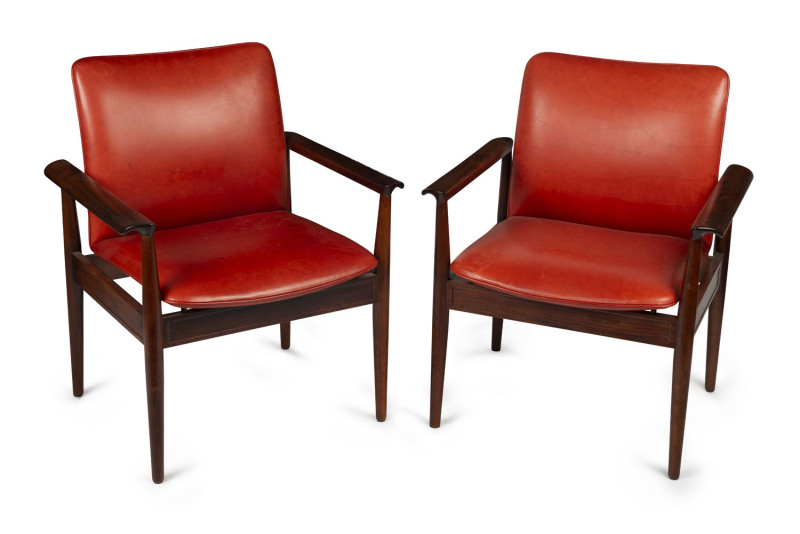 A pair of Danish rosewood armchairs upholstered in red leather, circa 1950s, 69cm across the arms