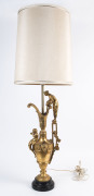 A gilt finished metal ewer based table lamp and shade, 106cm high overall