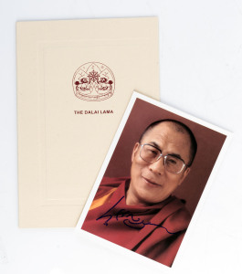 Tenzin Gyatso, the 14th DALAI LAMA, a signed photograph (15 x 10.5cm) of His Holiness The Dalai Lama.The signature was obtained directly from the Office of the H. H. The Dalai Lama and comes with the original folder. (2 items).