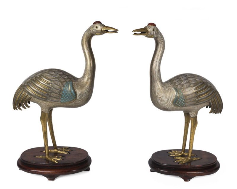 A rare pair of Chinese cloisonne cranes on carved wooden bases, Qing Dynasty, Daoguang Period 1820-1850, 47cm high