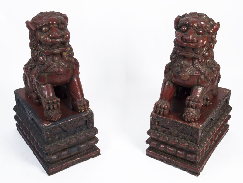 A pair of Chinese lacquered and carved timber Foo Dogs, early 20th century, 71cm high