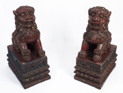 A pair of Chinese lacquered and carved timber Foo Dogs, early 20th century, 71cm high