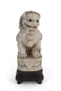 A Chinese carved ivory Foo dog on carved timber stand with silver inlay, circa 1920s, 18.5cm overall