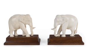 A pair of carved ivory elephant statues on wooden bases, 19th/20th century, 12.5cm high overall