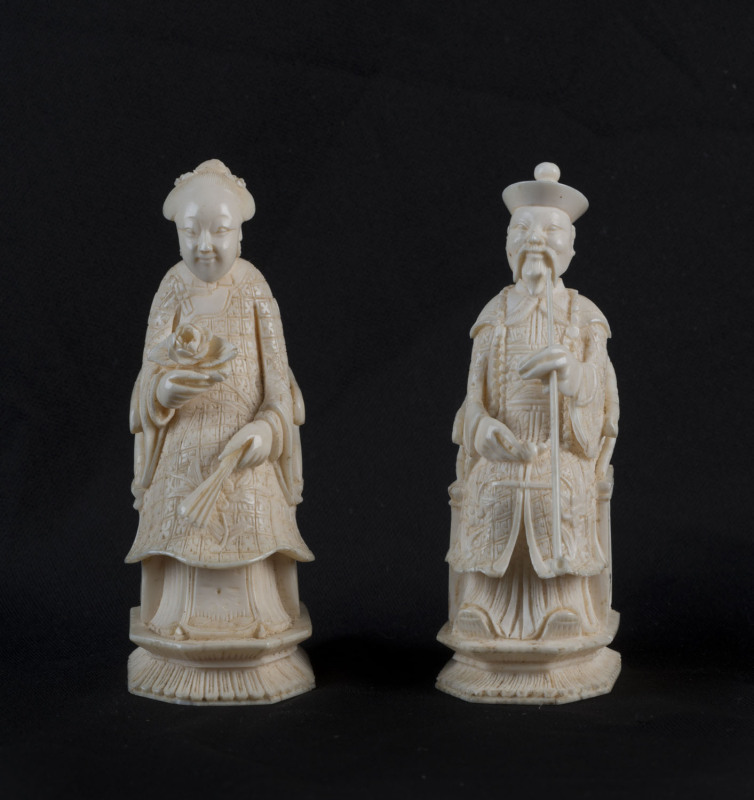 A pair of Chinese carved ivory seated figures, one smoking an opium pipe, 19th century, 8.5cm high