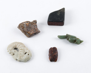 Chinese stone seal and four Chinese carved stone amulets, the largest 7cm