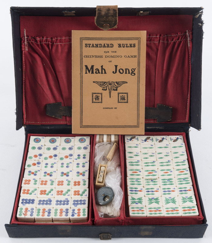 A Chinese Mah-Jong set in leather and card case with bone and bamboo tiles, early 20th century, the case 29cm across