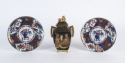 A Japanese Satsuma lidded vase together with a pair of Imari plates, Meiji Period, the vase 18cm high