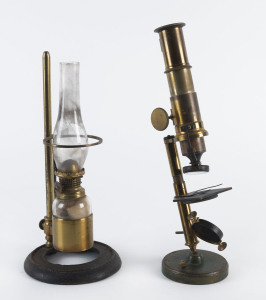 A brass microscope with all fittings intact, 19th century, 30cm tall. Accompanied by the rare kerosene lamp unit (glass flue broken). Ex. Hardwicke Knight Collection, Dunedin. (2 items).